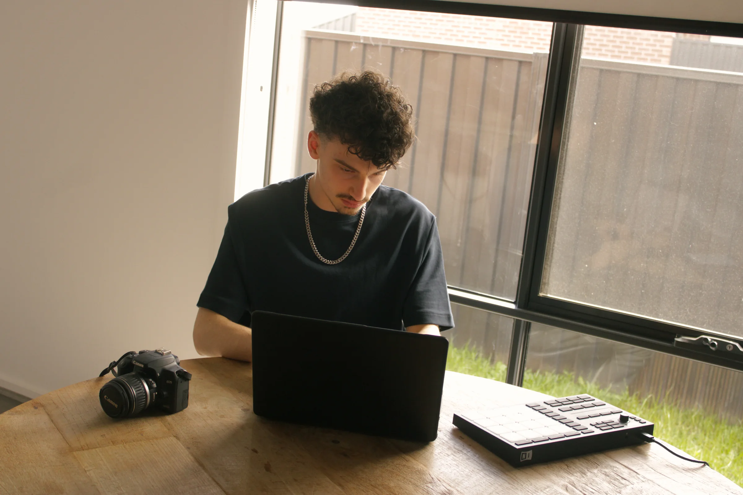 Me working on my website, sitting at my desk with my gear.